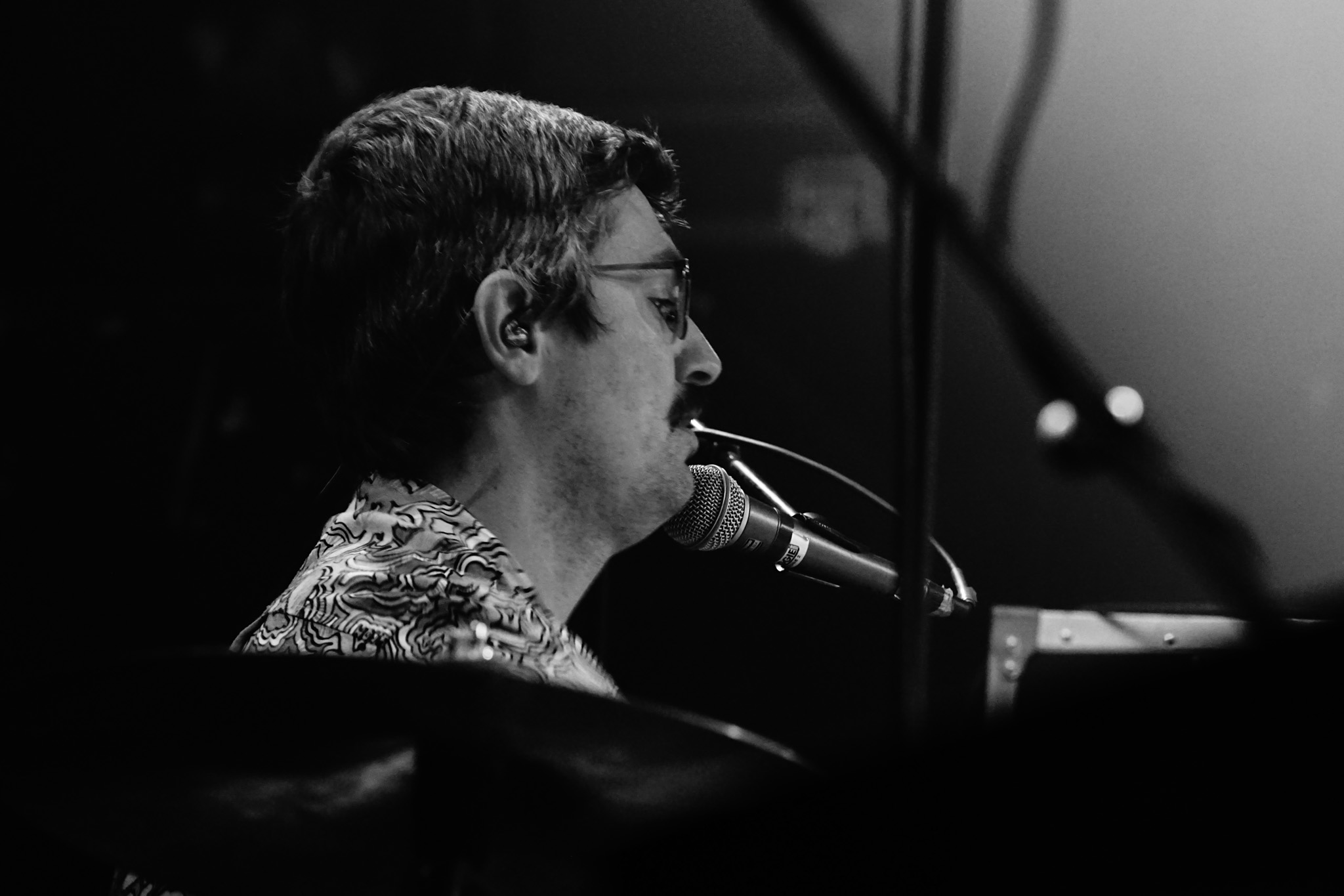 Eric Fischer playing drums and singing